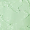 Textura do produto de creme para mãos FPS 60 da Ollie de cor esverdeada.