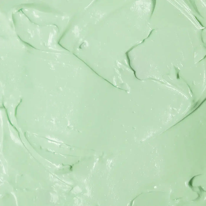 Textura do produto de creme para mãos FPS 60 da Ollie de cor esverdeada.